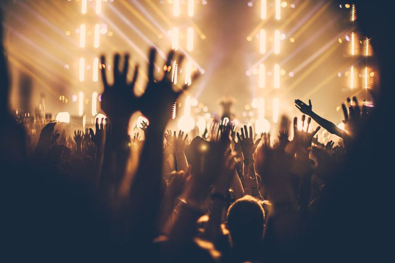 people-enjoying-music-concert-with-hands-raised-at-night-589722553-59c6f64a054ad900114501dd.jpg